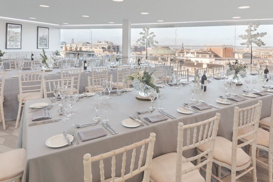 Top table set up with grey tablecloths and white chiavari chairs